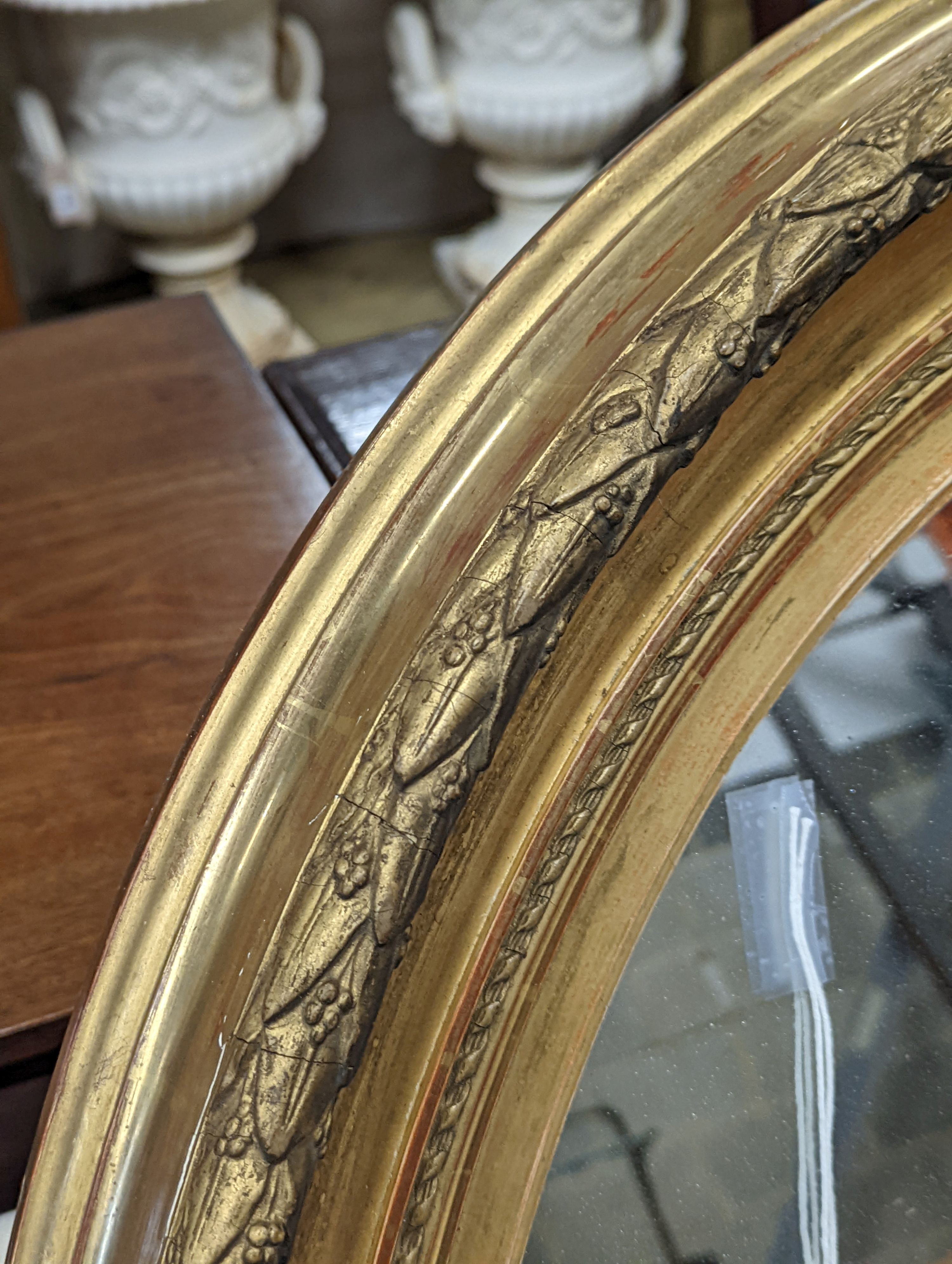A Victorian oval giltwood and gesso wall mirror, width 80cm, height 94cm